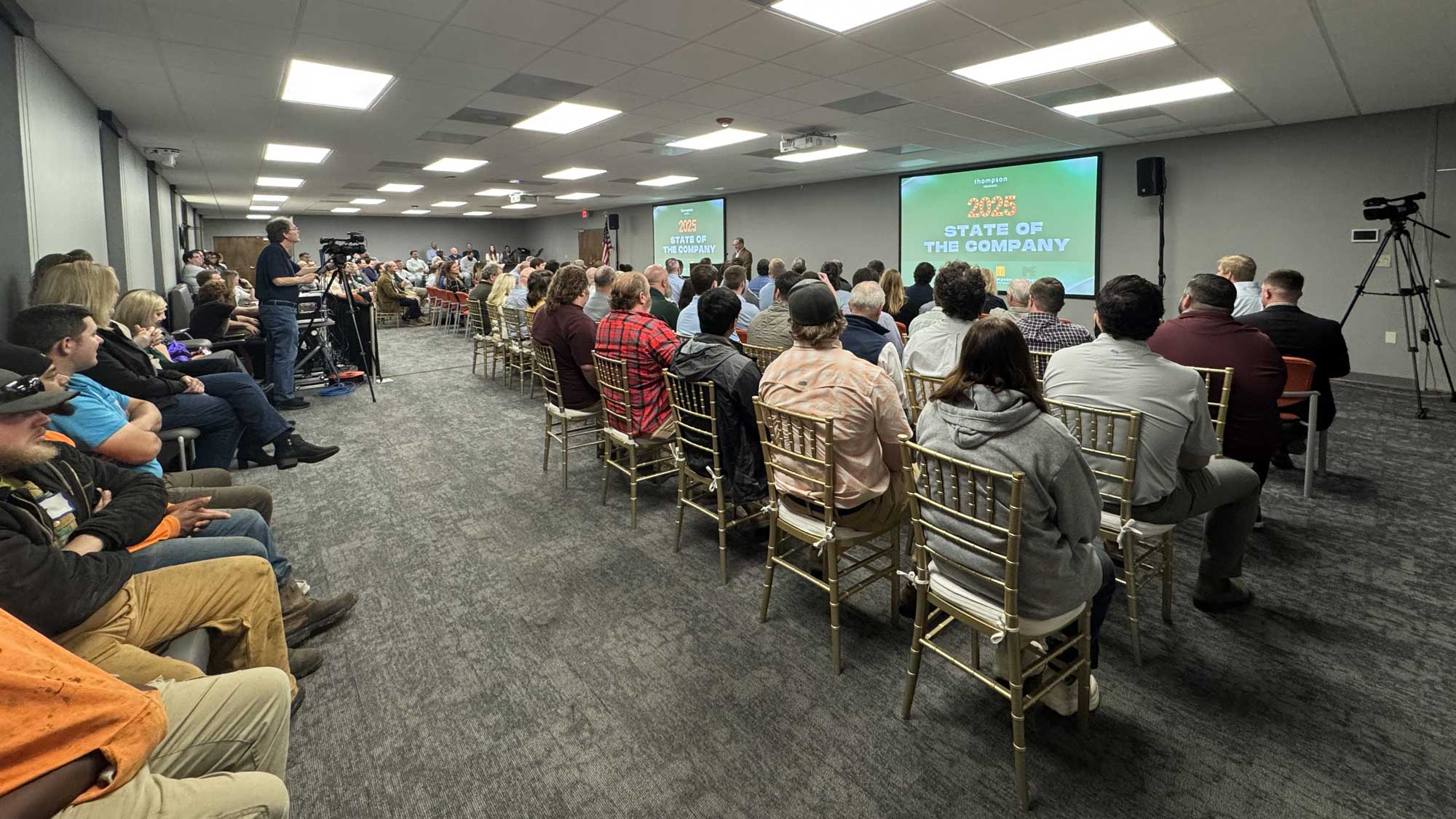 Audience gathered for a State of the Company presentation in a conference room, 2023.